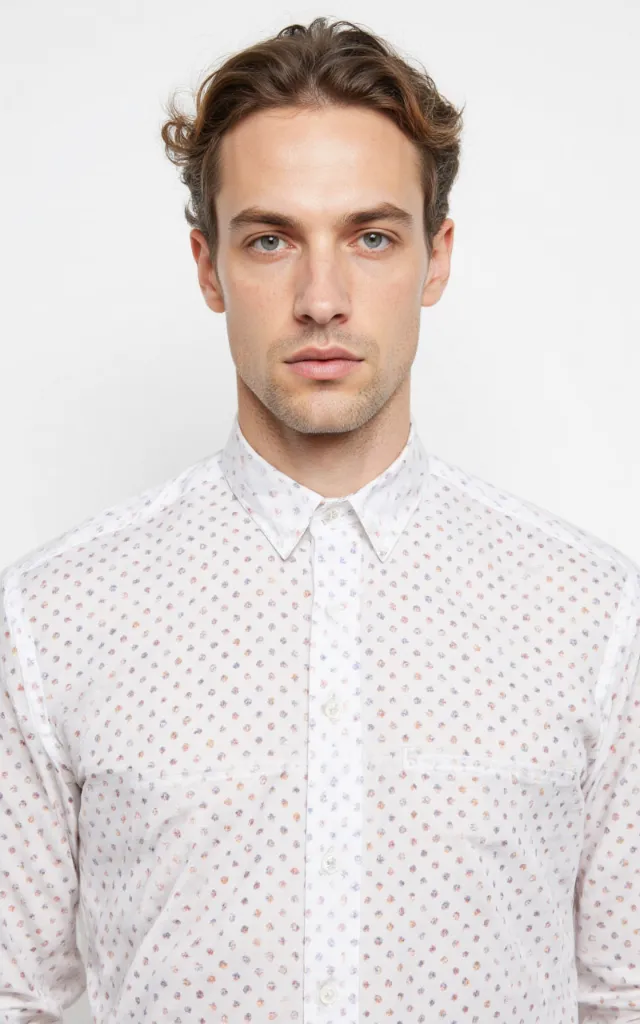 A French model wearing a Polka   dot pattern   printed shirt, against a white background, in a front   facing bust portrait